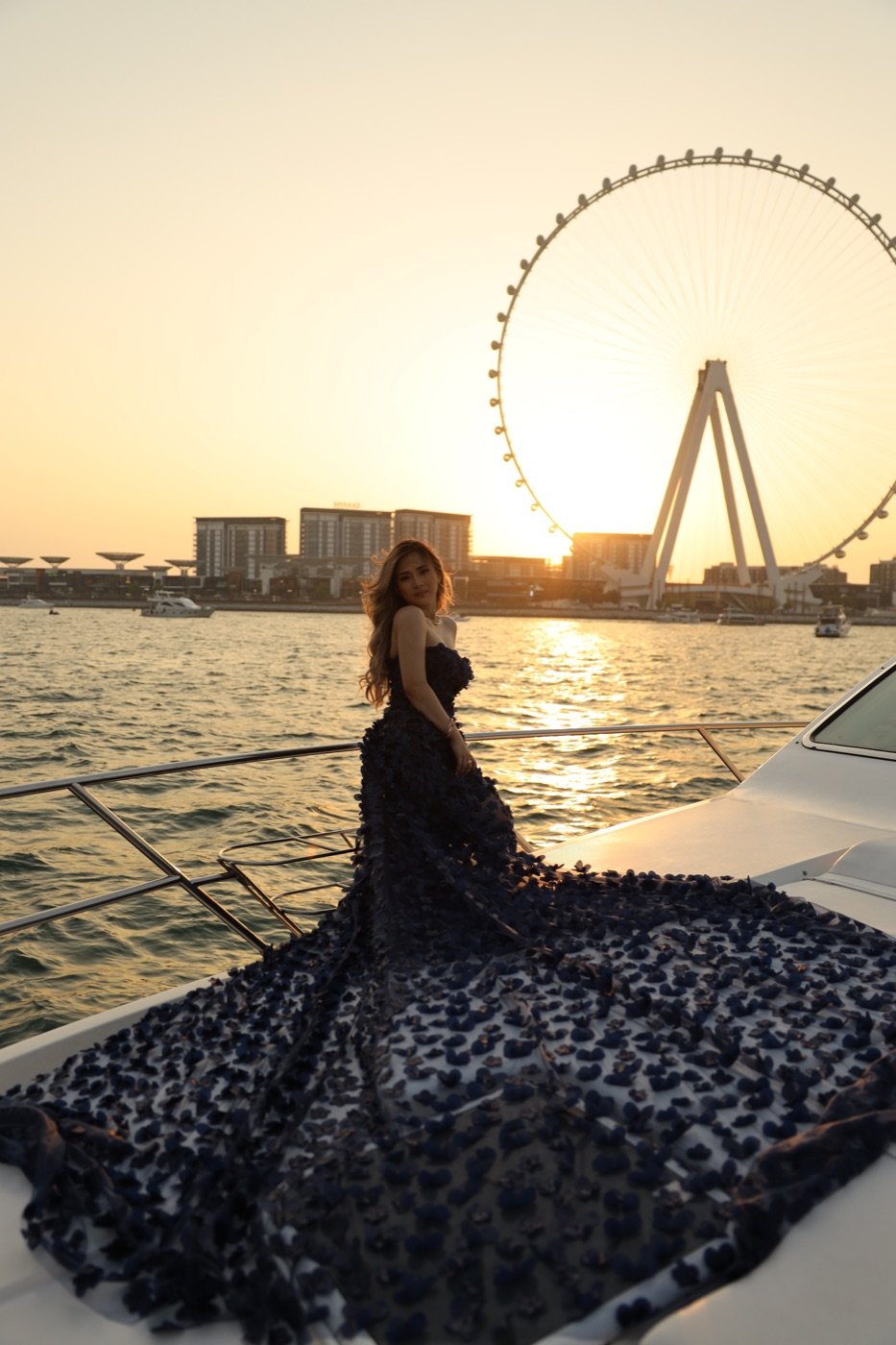 Model wearing a floral flying dress on a private yacht in Dubai
