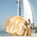 Gold flying dress couple photoshoot in Dubai city with Burj Khalifa and luxury professional photography experience