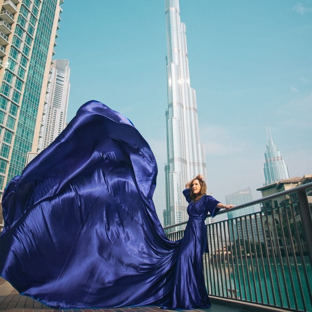 Blue flying dress photoshoot in Dubai city with Burj Khalifa and luxury professional photography experience