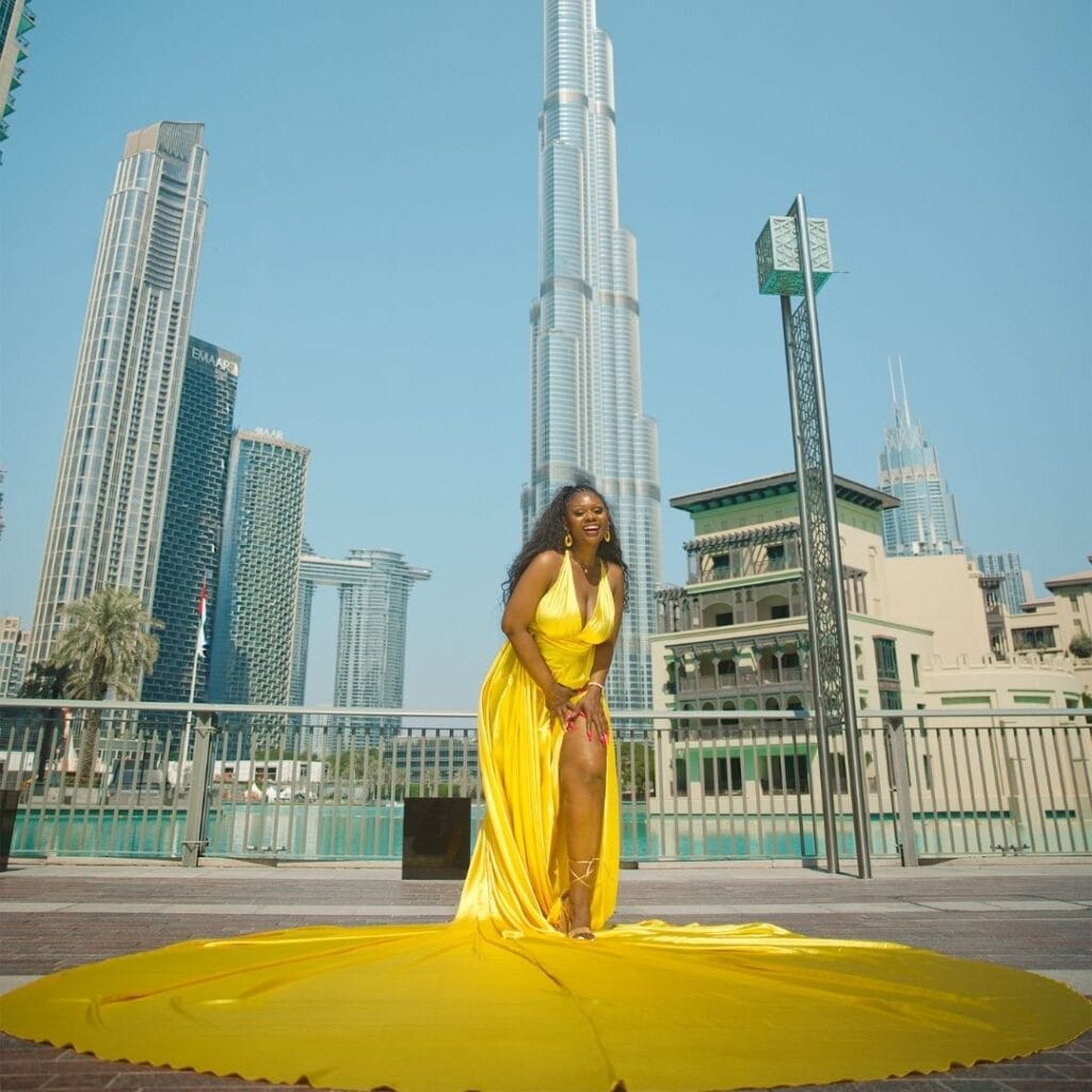 Yellow flying dress photoshoot in Dubai city with Burj Khalifa and luxury professional photography experience