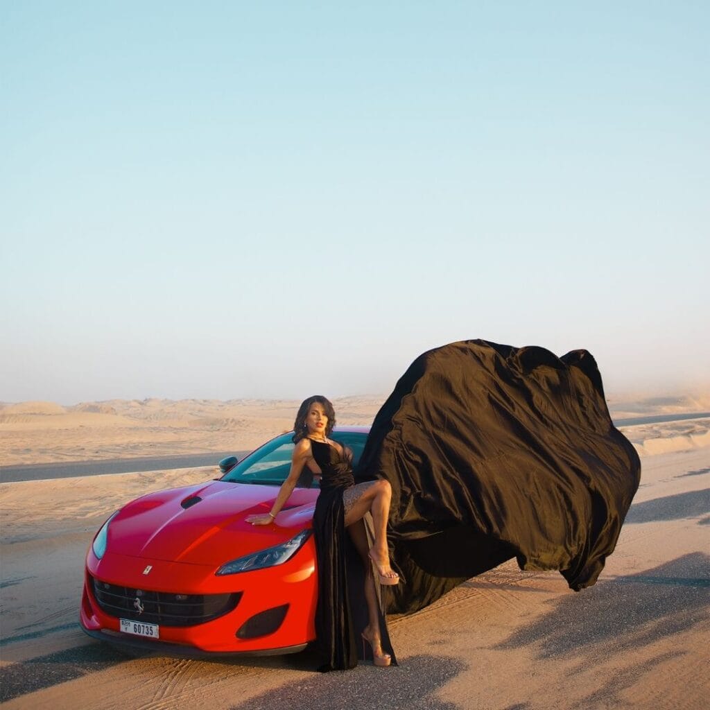 Black flying dress photoshoot in Dubai desert with luxury car and premium professional photography experience