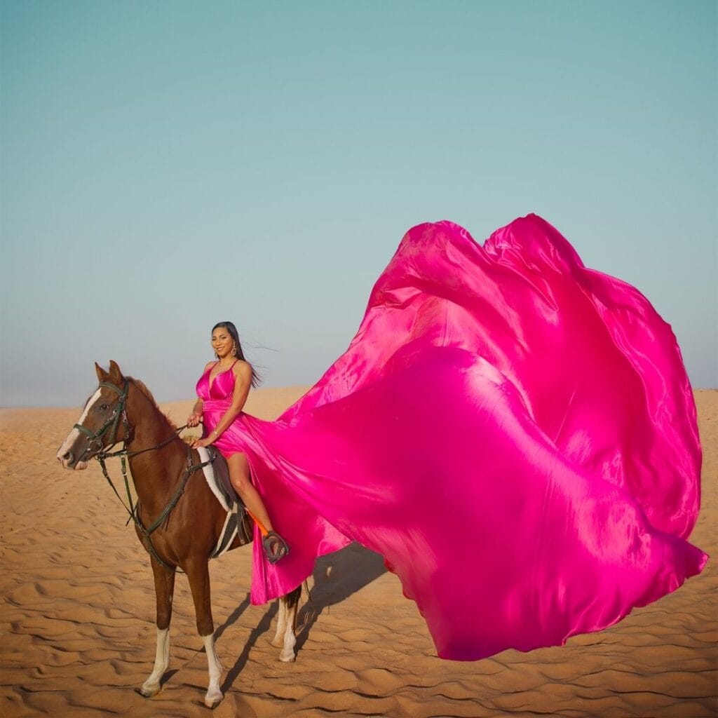 Pink flying dress photoshoot in Dubai desert with horse and luxury professional photography experience