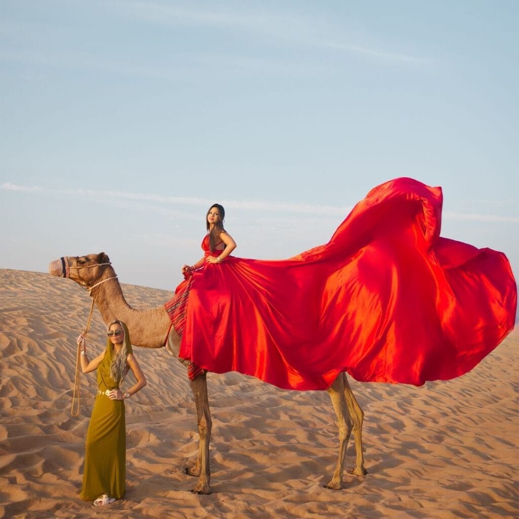 Mother and daughter flying dress photoshoot in Dubai desert with red flowing dress and professional photography
